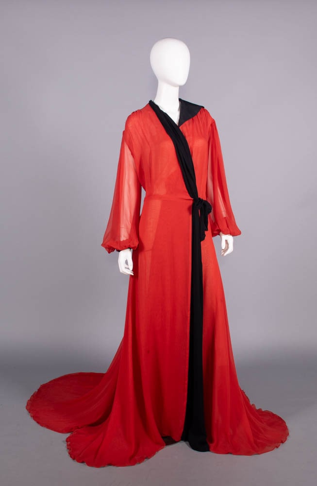SILK GEORGETTE PEIGNOIR GOWN, 1930s: Scarlet silk georgette w/ asymmetrical ribbed silk half collar & pleated cuff, single black chiffon draped shawl collar from right shoulder to closure at left hip & continuing to front hem, ruched SH 
