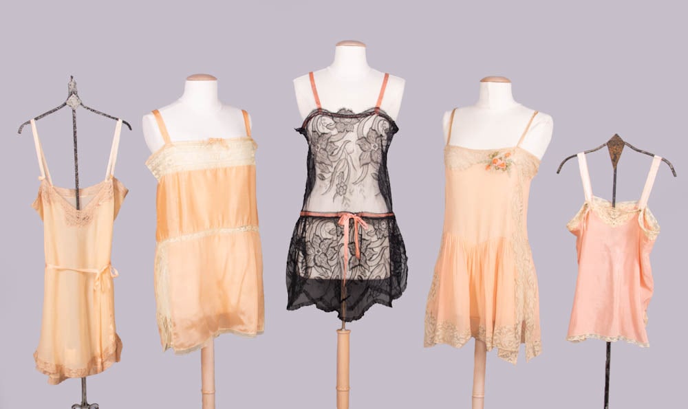 FIVE SILK & LACE STEP-INS OR CAMISOLES, 1920-1930: 1 peach crepe georgette step-in w/ guipure lace, B 32”, L 30”, (few tiny stains); 1 peach silk crepe step-in w/ mm lace edging & insertions, B 42”, L 32”, (light stains up to 1
