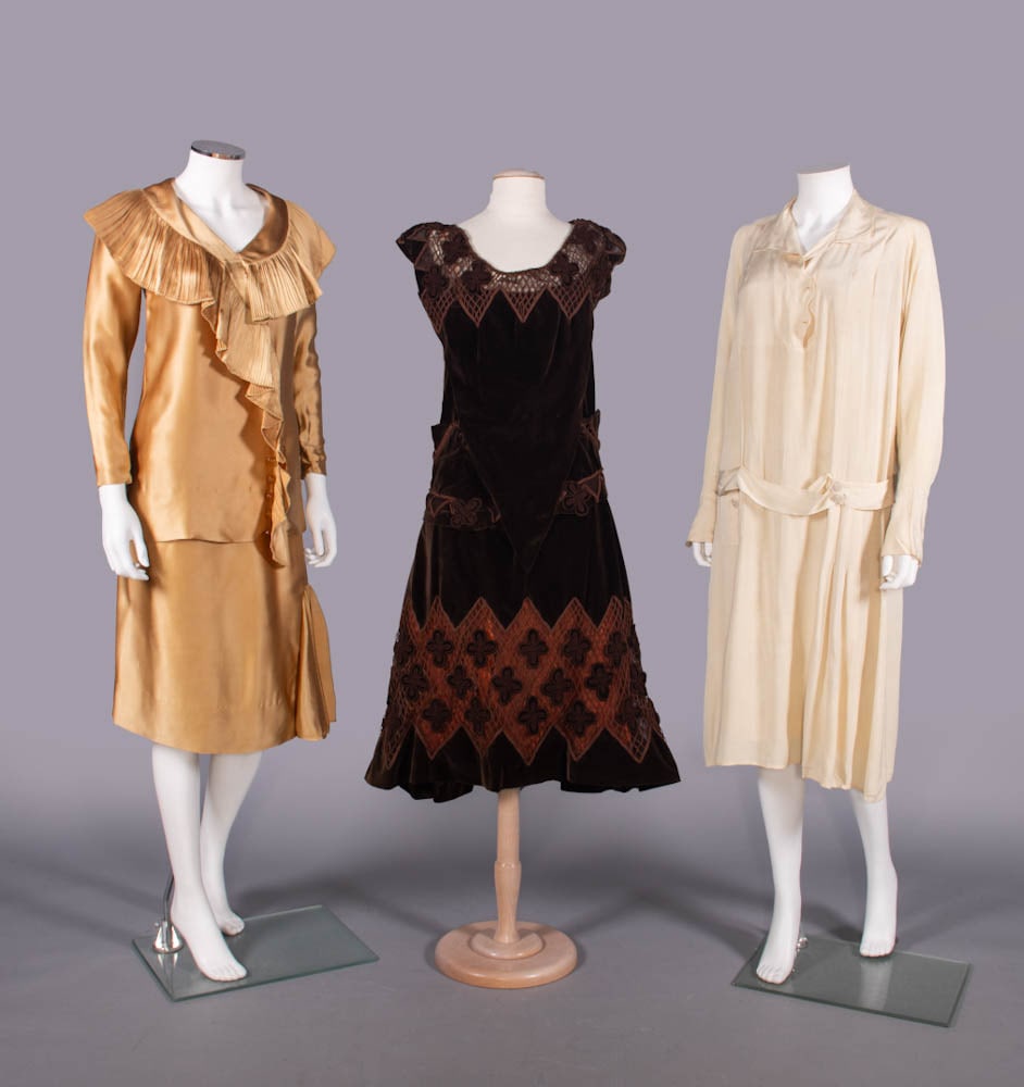 THREE SILK OR VELVETEEN DRESSES, 1924-1928: 2-pc gold silk crepe back satin w/ knife pleated shawl collar into faux surplice drape, long sleeve w/ snap wrist, skirt w/ turn back ruffle at left SS, 1928, B 33”, L 28”, skirt W 32&rdqu