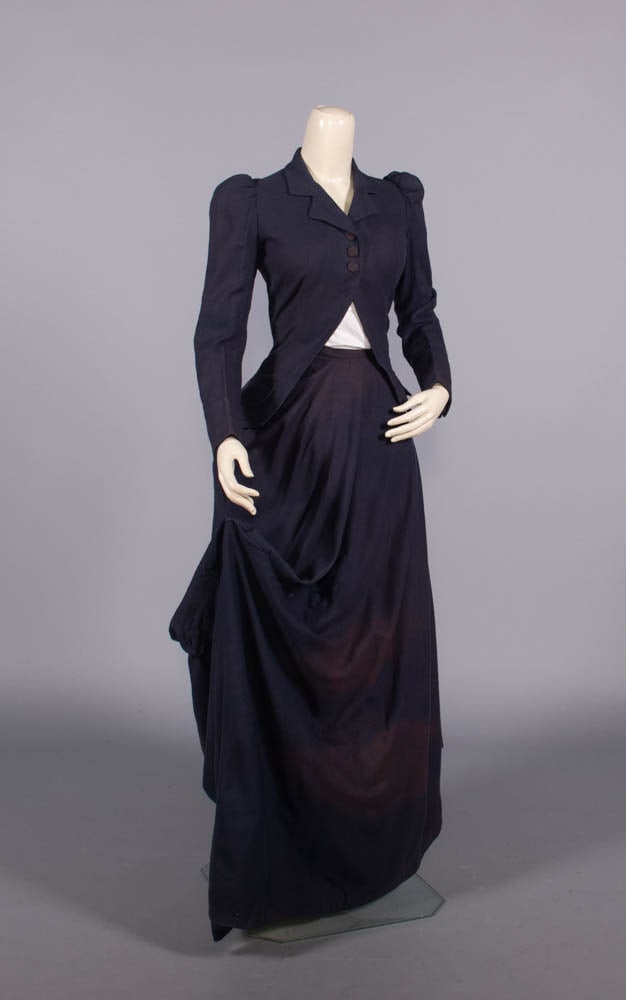 WOOL BROADCLOTH RIDING HABIT, 1890: Navy wool broadcloth riding habit w/ 3 ribbed silk-covered CF buttons, skirt w/ button closure, 1890, bodice B 32”, L 20”, skirt W 22”, L 36”-48”, (white slip N/I, light 