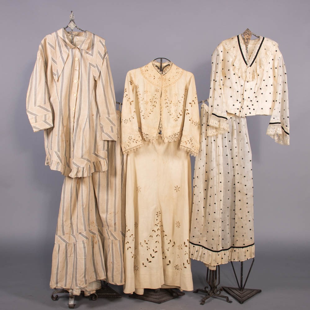 THREE COTTON OR LINEN DAY DRESSES, 1870-1904: 2-pc day dress of tan, black & white striped cotton w/ bone buttons, detachable collar & gored skirt w/ gathers at CB, early 1870s; 2-pc day dress of white linen w/ eyelet embroidery & bobbin lace, c.