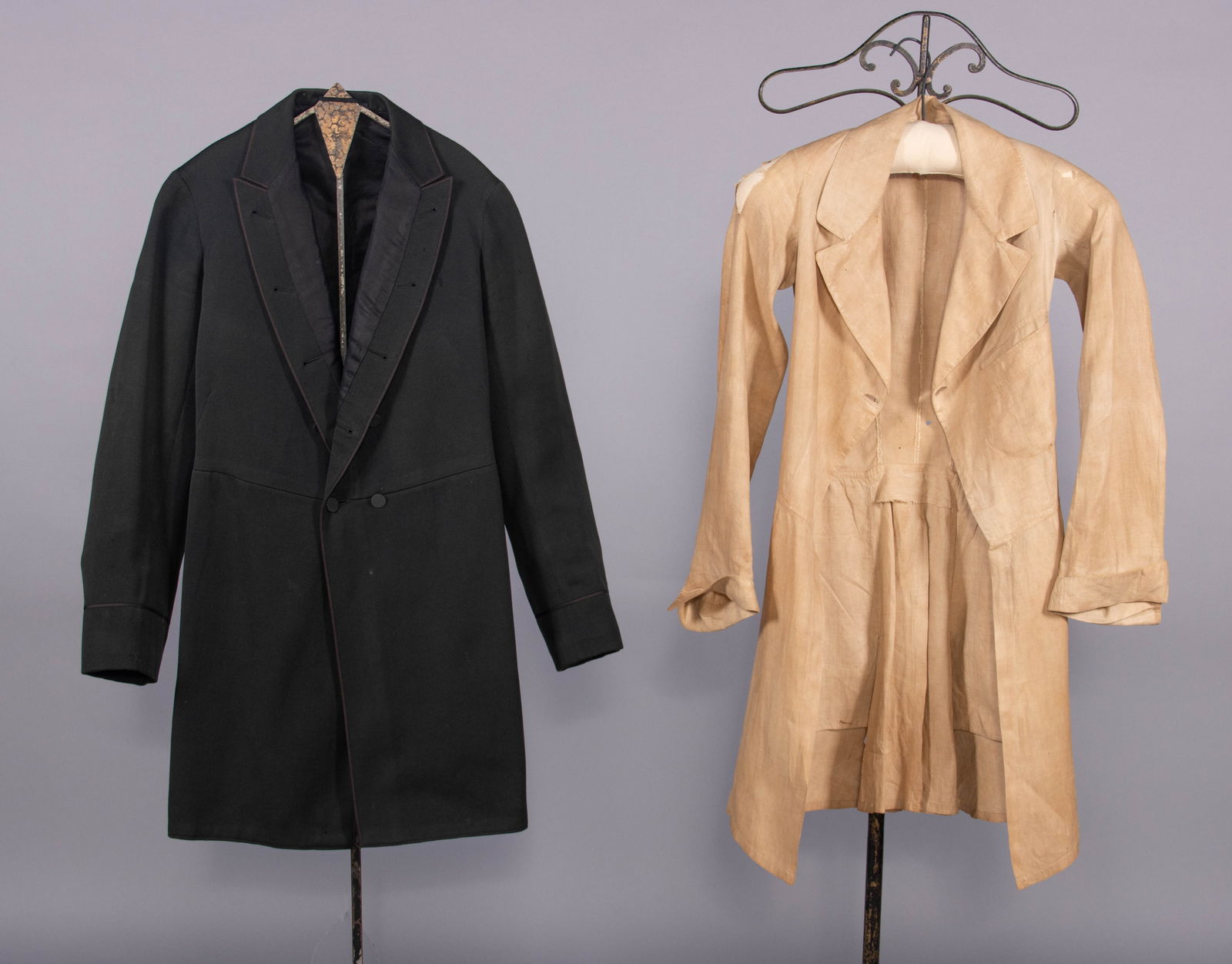 WOOL WEDDING COAT & LINEN FROCK COAT, c. 1885 & c. 1840: 1 wedding coat of black wool twill w/ brown silk braid edging & black silk twill lining, 1885, very good; 1 frock coat of natural colored linen w/ notched collar, vest pocket, piped collar, CF & cuffs