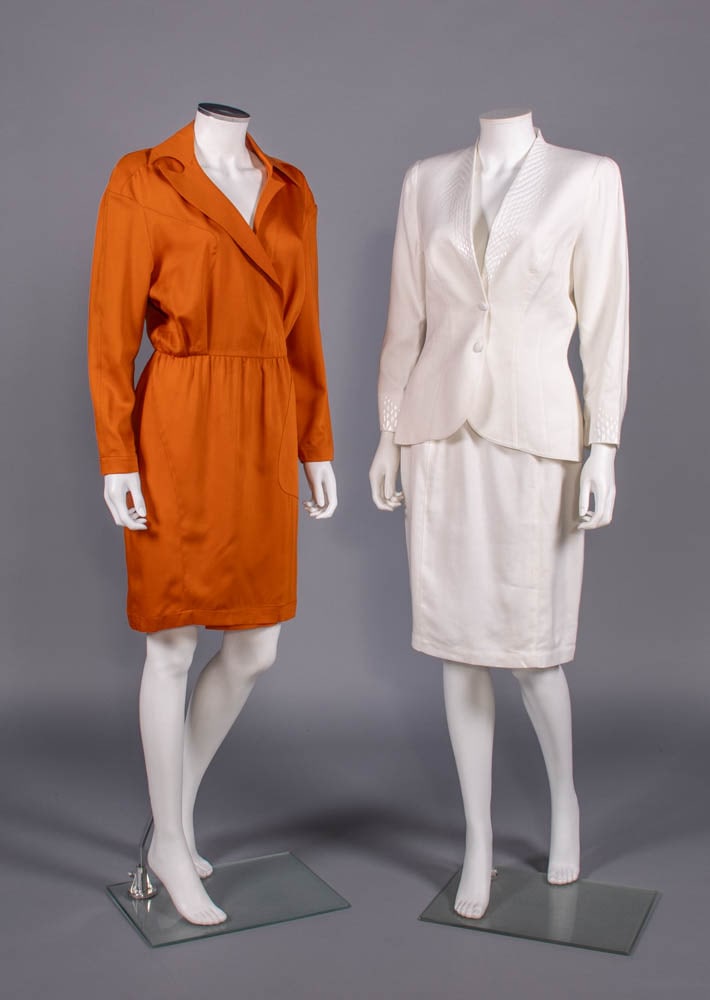 THEIRRY MUGLER DAY DRESS & SKIRT SUIT, PARIS, 1980s: 1 orange wool asymmetrical faux wrap dress, label “Thierry Mugler, Paris”; 1 white linen-blend skirt suit w/ applied snakeskin paillettes to collar & cuffs, label “Thierry Mugler, Paris&rdqu