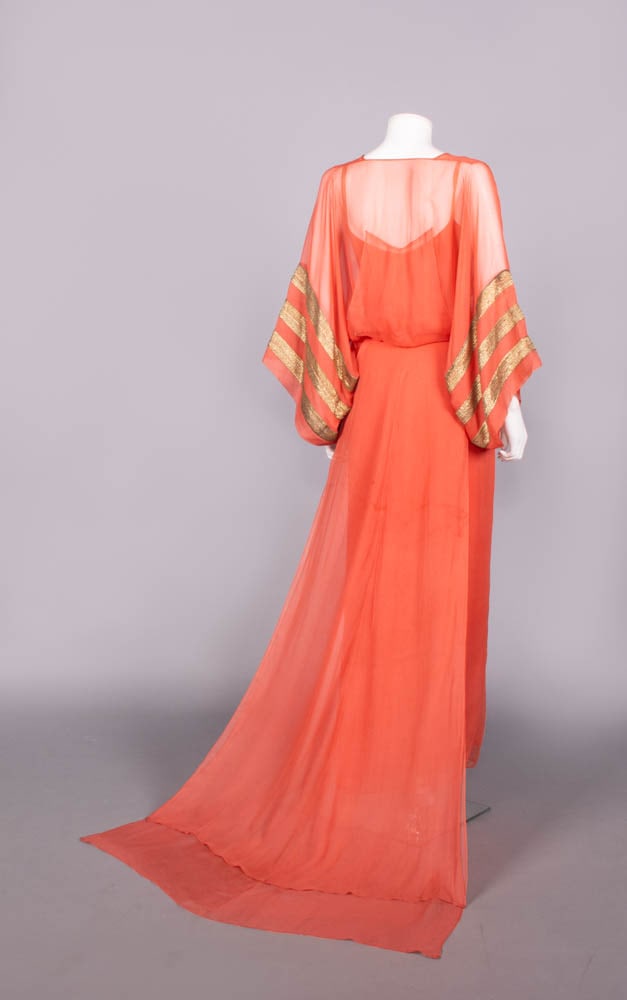 SILK CREPE & LAME' BOUDOIR GOWN, c. 1930: Tangerine silk crepe chiffon boudoir gown w/ flat gold lame' bands applied to full sleeves, wrap panels into W ties, square back train, original silk crepe slip w/ chiffon hem, 1930, dress B 34”
