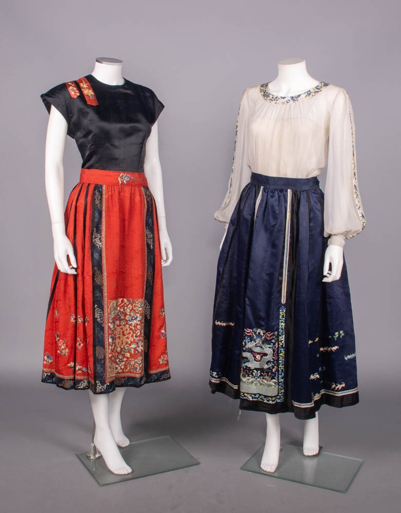 TWO MANDARIN SKIRTS REMADE INTO FASHIONABLE DRESS, 1930-1940s: Both ensembles remade from early 20th C Mandarin skirts: 1 black silk satin short slv blouse w/ Chinese silk embroidered panels applied to right SH, B 38”, L 21”, (pulls B, light stains up