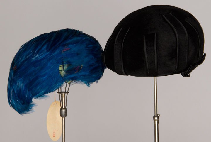 TWO CHRISTIAN DIOR HATS, 1950-1960: Both labeled: 1 covered in bright blue & green feathers & 1 black fur felt inverted bowl, excellent; t/w 1 tri-color Lilly Dache tall velvet toque, excellent.