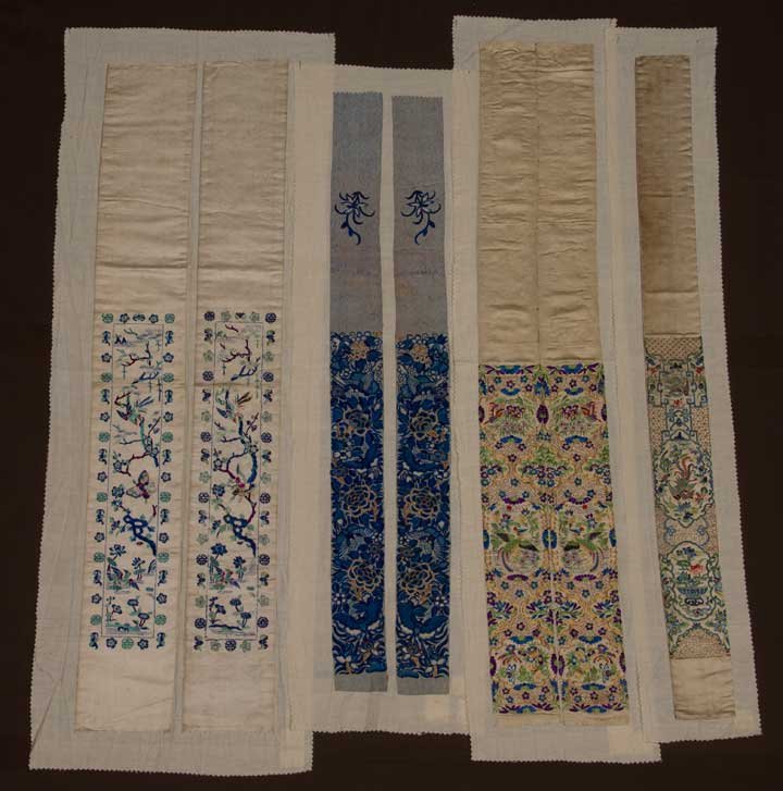 THREE PAIR SLEEVE BANDS, CHINA, 19TH C: 2 pair on white silk satin: 1 w/ magenta & blue branches & small colorful birds & butterflies; 1 w/ dense & colorfully embroidered birds, flowers & butterflies against a gold couched grid; 1 pair on p