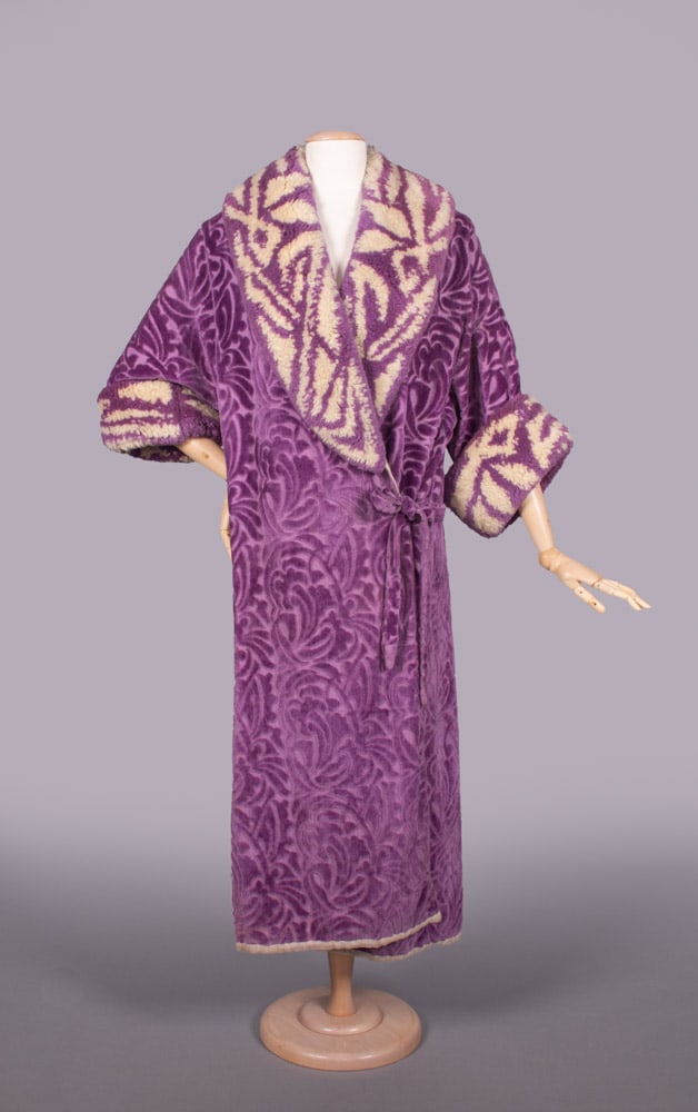 BECKER FILS COTTON VELVET COAT, PARIS, 1925: Purple cut cotton velvet coat w/ lapel & cuff of cream & purple shag pile in motif based on velvet body, free front w/ tie closure, lined in white china silk, label “Marque Deposee Becker Fils, Pari