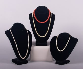 FOUR PEARL OR CARNELIAN STRANDS WITH PLATINUM OR GOLD CLASPS