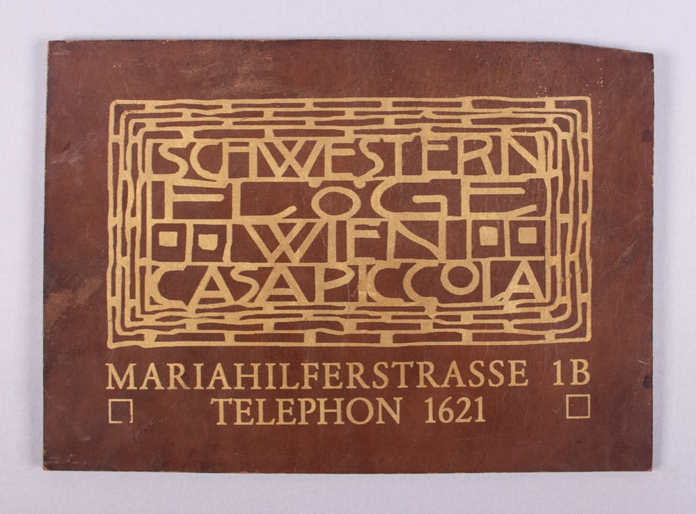 SIGN BY JOSEF HOFFMAN FOR EMILIE LOUISE FLOGE [MUSE OF GUSTAV KLIMT], 1904: Gold stencil on leather store sign for Viennese haute couture house, “Schwestern Floge, Wien Casa Piccola, Mariahilferstrasse 1B Telephon 1621", designed by Josef Hoffman. Founded by Gustav Klimt's