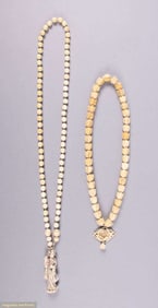 TWO CARVED FIGURAL OR FLORAL MOTIF NECKLACES