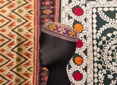 EMBROIDERED MANS CAP & TWO EMBROIDERED OR IKAT TEXTILES, EARLY-MID 20TH C