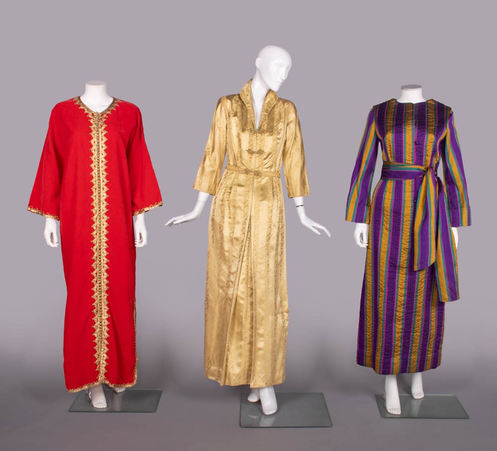 THREE REGIONAL INSPIRED DRESSING OR HOSTESS GOWNS, 1950-1960s: 1 red velveteen caftan in North African style w/ gold cording & buttons, c. 1960s, B 44”, L 56”, (few areas of minor wear/crushing to pile, few tiny stains near hem, light wear & pulls to 