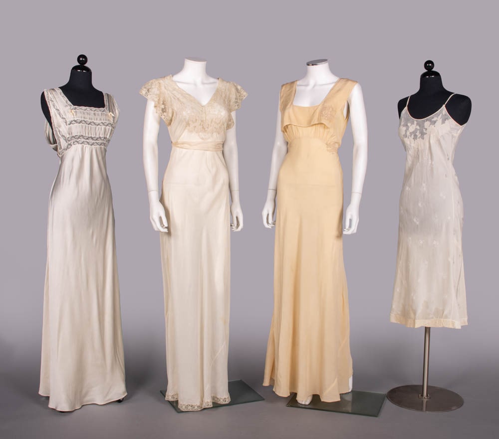 FOUR SILK & LACE BOUDOIR GOWNS OR SLIPS, USA, 1930s: 1 white silk charmeuse nightgown w/ tucking & lace inserts, B 34”, L 60”, (light discoloration lower skirt/hem) Excellent; 1 white china silk lingerie w/ lace bodice & sash, label “Henri