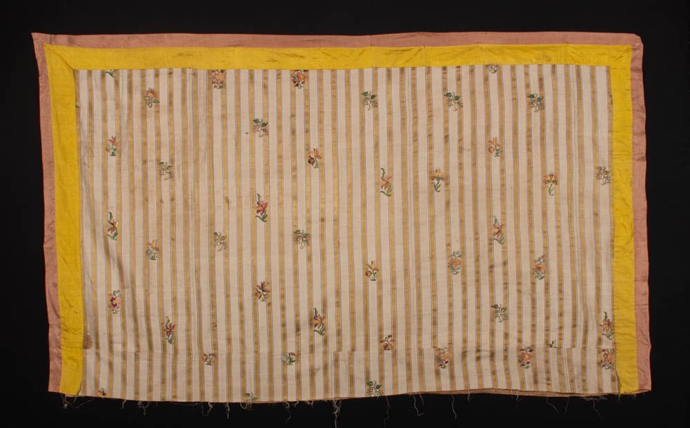 FLORAL EMBROIDERED STRIPED SILK PANEL, 1760s: Cover of silk w/ woven pattern of yellow satin stripe edged in pink between narrow blue stripes on a silk shantung ground w/ polychrome silk floss embroidered floral motifs scattered throughout, appli