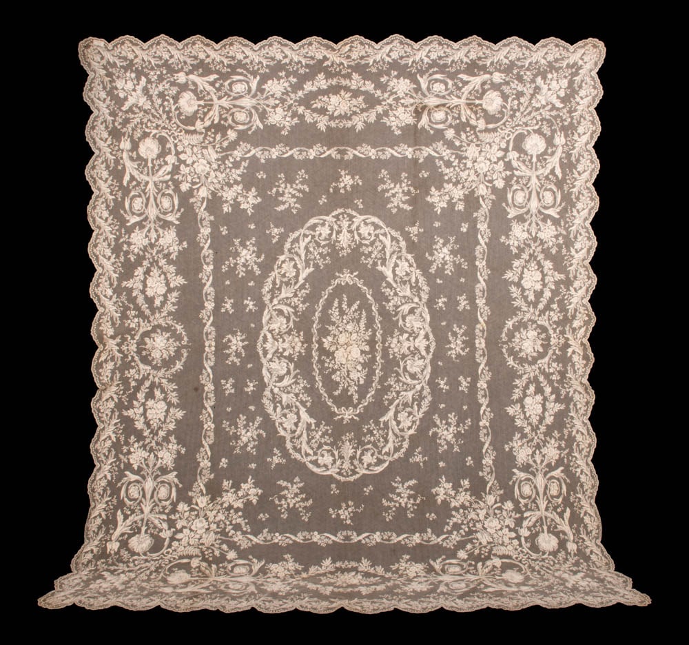 TAMBOUR EMBROIDERED TABLE COVERING, 1860-1880: Tambour embroidered table covering w/ typical floral center medallion, floral sprays, scrolling foliate, vine, ribbon & sprig border motifs scalloped edge, likely Nottingham, England, 77.5” x 92