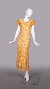 PRINTED SILK CREPE GARDEN PARTY DRESS, c. 1934: Silk crepe chiffon party dress w/ cream & green floral motif on tangerine ground w/ double gathered SH cap, velvet ribbon W band, B 33”, W 25”, L 54”, (slip N/I, few