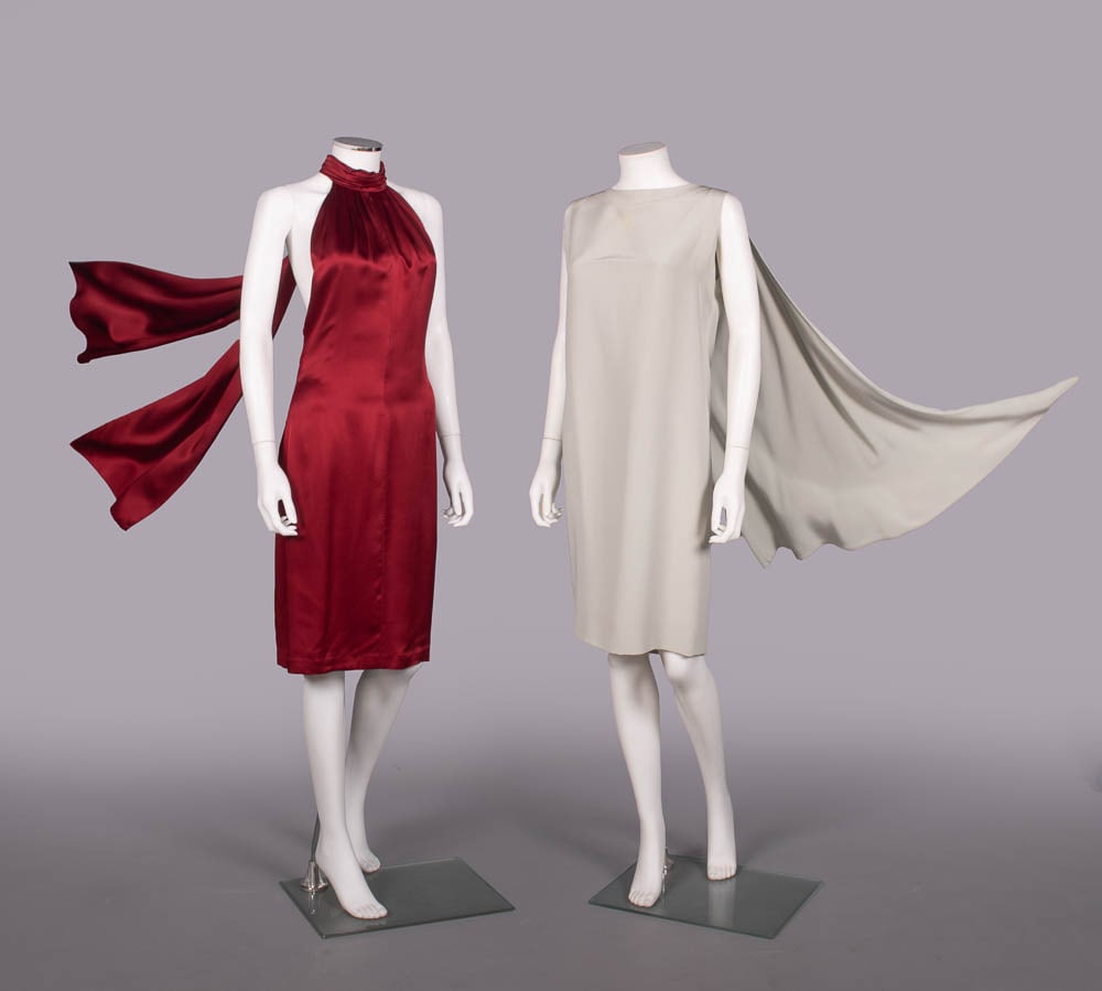PIERRE CARDIN & GUY LAROCHE SILK PARTY DRESSES, PARIS, 1990-2000s: 1 wine red silk satin evening dress w/ CB falling panels from pleated halter neck over open back, label “Guy Laroche Femme”, B 34”, W 28”, L 40”, (light 2” stain near l