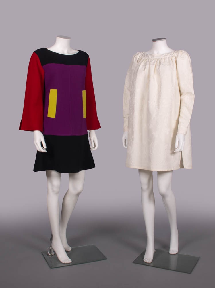 TWO CHRISTIAN LACROIX MINI DRESSES, PARIS, 1990s: 1 red, purple, black colorblock wool crepe mini dress w/ chartreuse fitchet pockets, label "Christian Lacroix", B 38", W 36", L 34", (few tiny pulls); 1 white linen damask tunic mini dress w/ raglan s