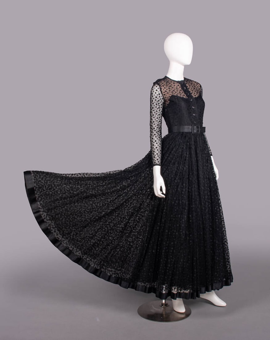 BILL BLASS TULLE & SILK EVENING GOWN, USA, 1970s: Black tulle gown w/ woven satin polka dot over black silk taffeta, long sleeve illusion bodice, double layer skirt & original self-covered belt, label "Bill Blass', B 34”, W 28", L 60", (light w