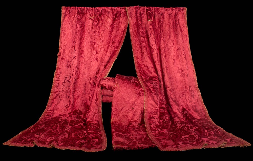 THREE PAIR OF PATTERNED RED SILK CURTAINS, USA, 1860s: Three pairs of curtain panels of red silk matelasse damask in large scale floral & foliate pattern w/ red silk corded passementerie trim at border, inner & lower edge of each panel, upper edge of each