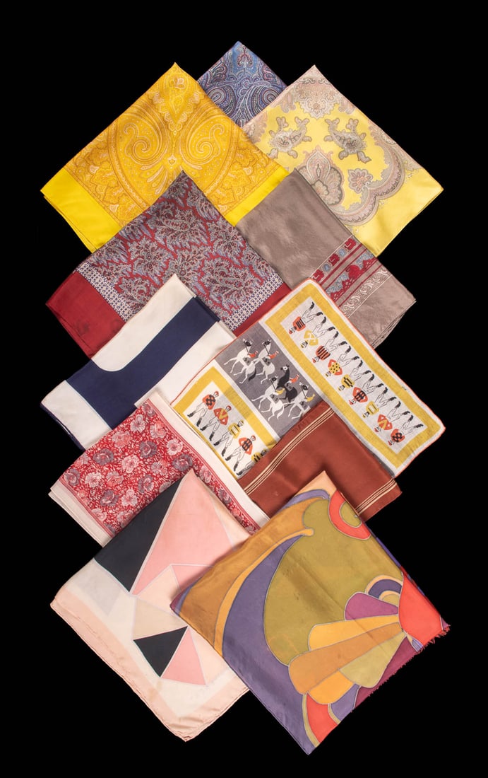 ELEVEN DESIGNER SCARVES, PARIS, LONDON & USA, 20TH C: 1 multicolor lady’s face motif, signed "Calisete(?), Paris", 17"x55", (0.25"-5" staining); 1 pink & black "Givenchy", 26"x27", (discoloration,spot stains); 1 red floral "Cacharel", 10"x54", (0.5" st