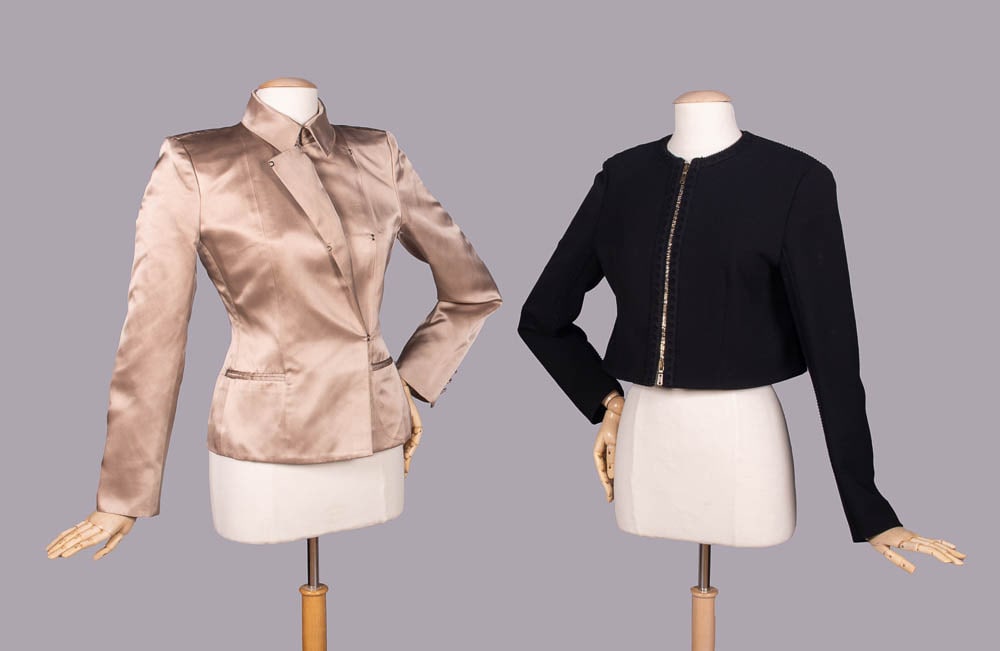 TWO YSL JACKETS, PARIS, S/S 2003 & 2000s: 1 champagne silk satin jacket w/ asymmetrical front closures, decorative blanket stitching, forged hook closures, welt pockets & decorative self-covered buttons, 2003, designed by Tom Ford, label "Yve