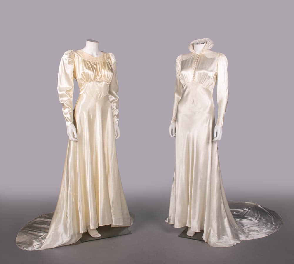 TWO SILK SATIN WEDDING GOWNS, c. 1938-1940: 1 cream silk satin wedding gown w/ lace yoke, puff long sleeves, piping to yoke & empire W, CB self-covered buttons & circular train, c. 1940, B 38", W 28", L 56"-75", (1.5" tear in lace LF SH, 1 miss