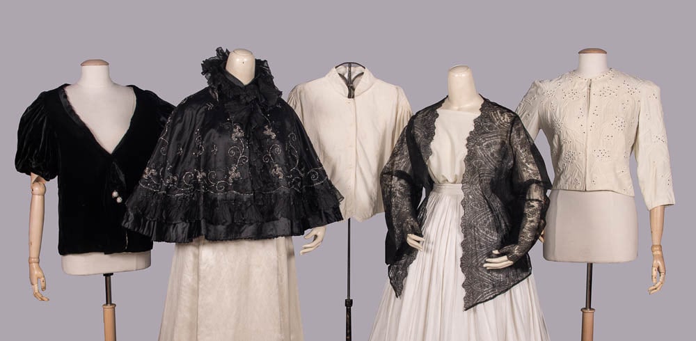 FIVE LADIES JACKETS OR CAPES, 1880-1960s: 1 short sleeved black silk velvet jacket w/rhinestone ball buttons, c. 1938, B 38", L 2", (neckline altered, wear/crushing, lining discolored, few missing stones) good; 1 black satin cape w/sequins, i