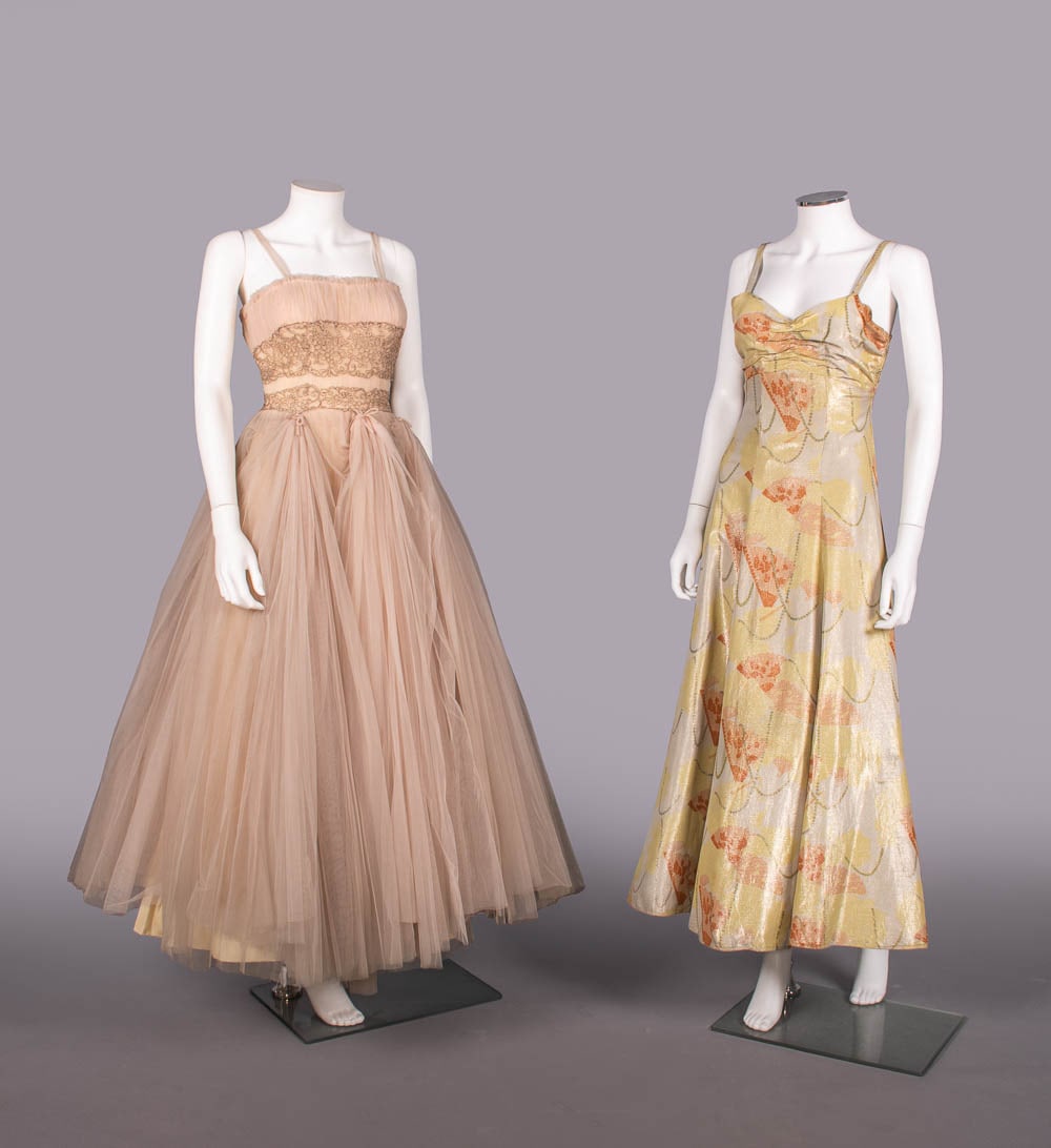TWO HENRI BENDEL PARTY DRESSES, 1930-1950s: 1 light pink nylon tulle dress w/ metallic lace applique, early 1950s, label "Henri Bendel, New York", B 30", W 23", L 55", (light discoloration lower skirt, few 0.25"-2" stains skirt, several tears t