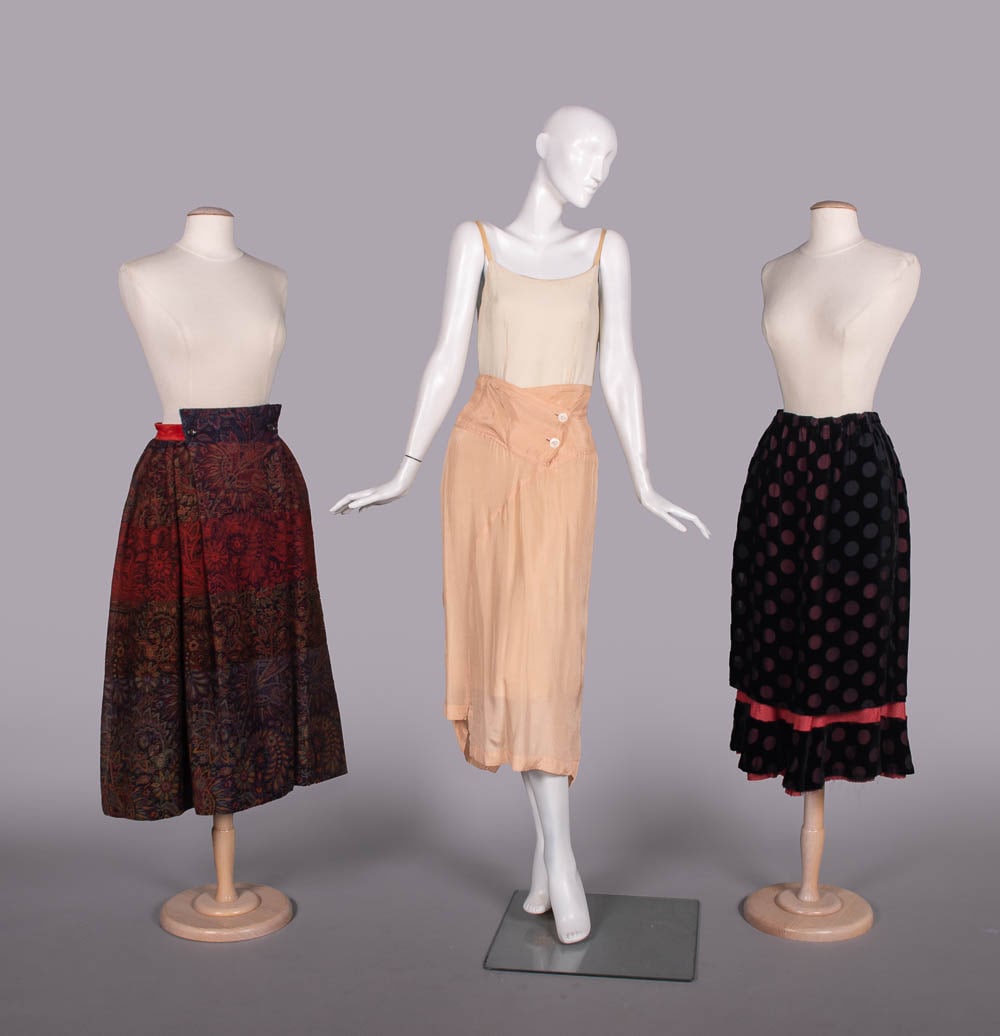 THREE COMME DES GARCONS SKIRTS, JAPAN, 1988-1990s: All w/ label "Comme des Garcons": 1 paisley patterned wool skirt w/ square fall front panel over button closures & cotton velvet waistband, 1988, W 28", L 32", (light wear, 0.25" repair lap, few tiny