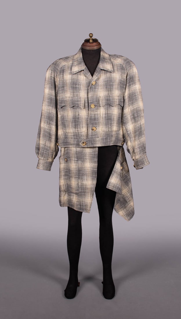 ISSEY MIYAKE CONVERTIBLE GENTS COAT, JAPAN, 1988-1989: Linen blend complex check coat in grey, off-white & wheat, CF button closures, patch pockets, applied belt style W band over zip running horizontally to remove skirt & convert to jacket, rayon lining,