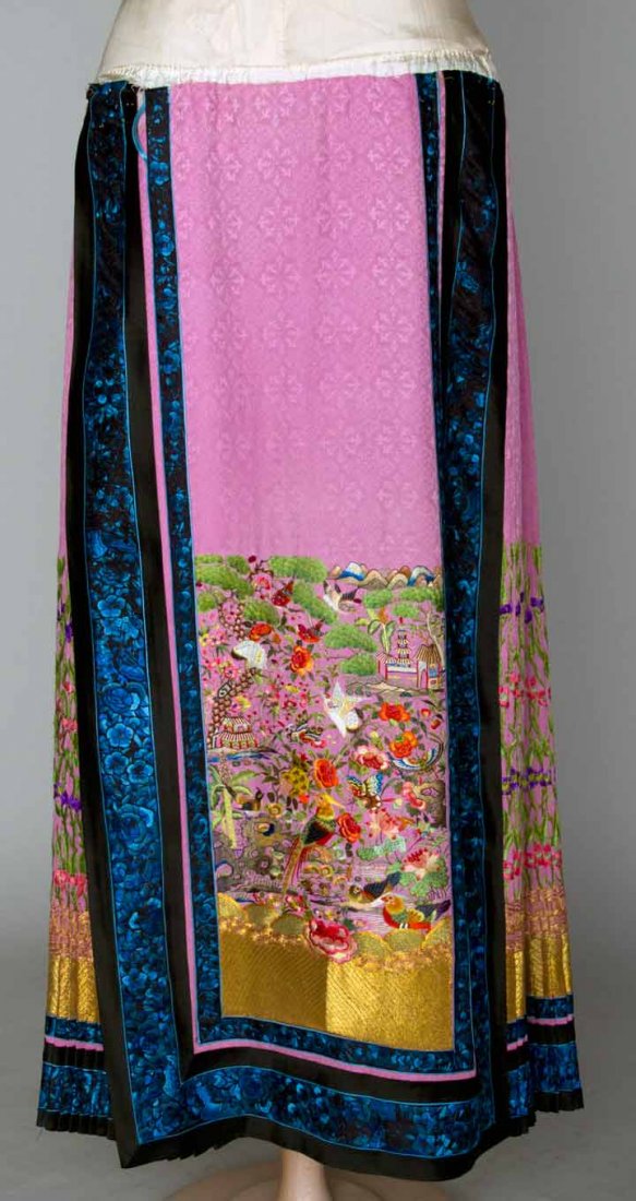 EMBROIDERED PINK SKIRT, CHINA, 1900-1930: Silk damask, sides smocked & embroidered, Cf & CB panels densely & colorfully embroidered w/ pagodas, butterflies, mountains, trees & 8 different bird species, (original muslin waistband missing, repl