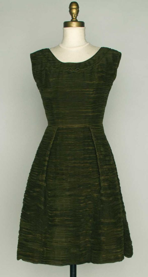 SYBIL CONNOLLY AFTERNOON DRESS, 1960s: Avocado green pleated fine linen, B 32", W 24", L 36", excellent.