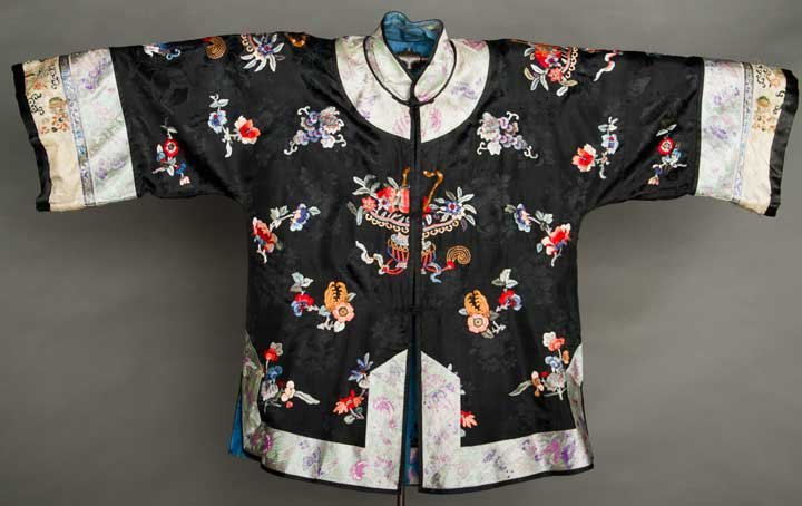 SILK EXPORT JACKET, CHINA, MID 20TH C: Black silk damask embroidered w/ flowers & fruit & embroidered ice blue & cream sleeve bands, very good.