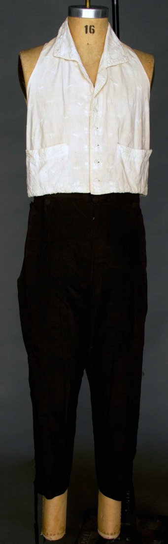 WEDDING VEST & BREECHES, AMERICA, 1809: 1 cream cotton vest w/ cream cotton embroidery, 2 front pockets, 2 pair back ties, Ch 38", 1 pair black silk knee breeches, fall front, 3 pockets, back lacing, W 32"-36", Inseam 20"; excellent. Proven