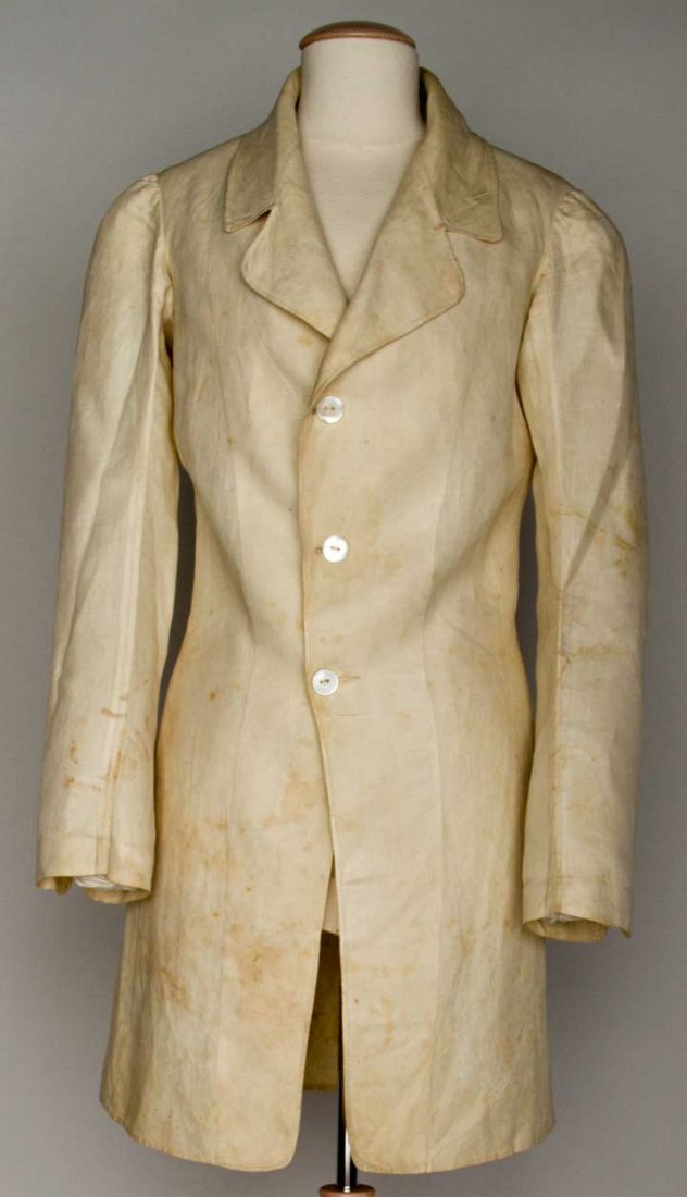 SEAMAN'S TOP COAT, AMERICA, 1840-1850: White linen, single breasted, cut-away front, CB pleat on coat skirt, horizontal back seam, (dirty) excellent.