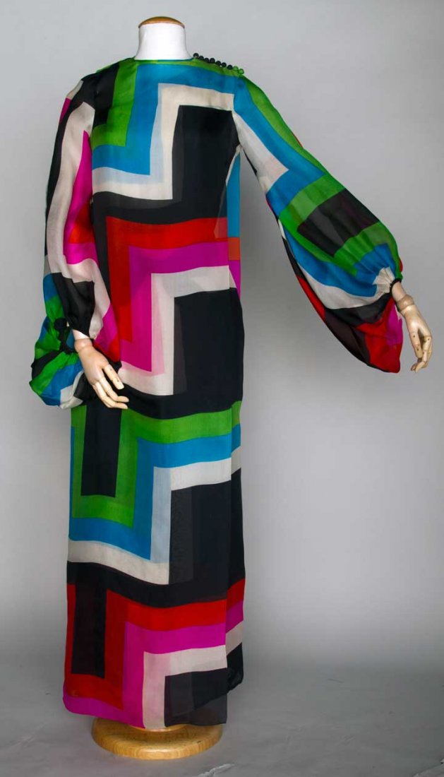 PIERRE CARDIN SILK EVENING GOWN, PARIS, 1970s: Single shoulder organdy sheath in black, white, blue, green, pink & orange geometric print, L side w/ long balloon sleeve, satin bow-front belt, optional tabard over-layer that buttons on L shoulder &