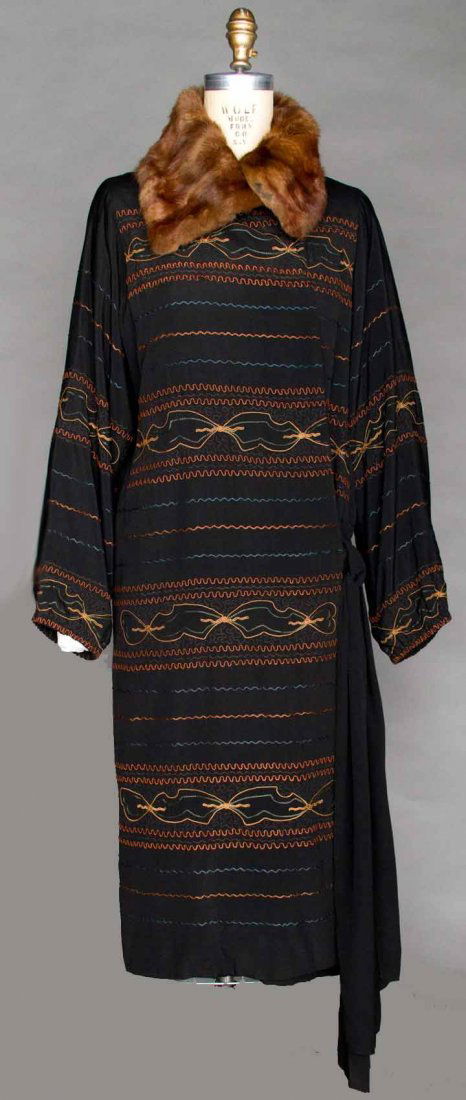 EMBROIDERED EVENING COAT, 1920s: Black silk w/ horizontal wavy line embroidery in rust, dark green & tan, mink collar, ties at L hip, Shoulder to Shoulder 15.5", Sleeve Length 24.5", Coat Length 48", excellent.