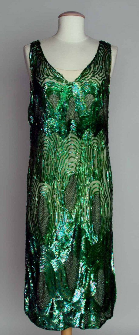 EMERALD SEQUIN PARTY DRESS, 1920s: All-over irridescent green sequins w/ bugle beaded ovals on net, B 38", H 40", L 44.5", (some sequin & bead loss) very good.