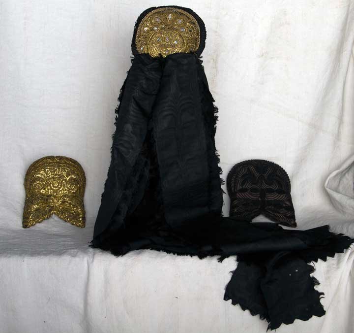 THREE WOMEN'S FOLK CAPS, GERMANY, 19TH C: 2 inverted U shape: 1 gold & 1 black beaded; 1 small gold cap w/ opalescent jewels & black silk ribbons; very good-excellent.