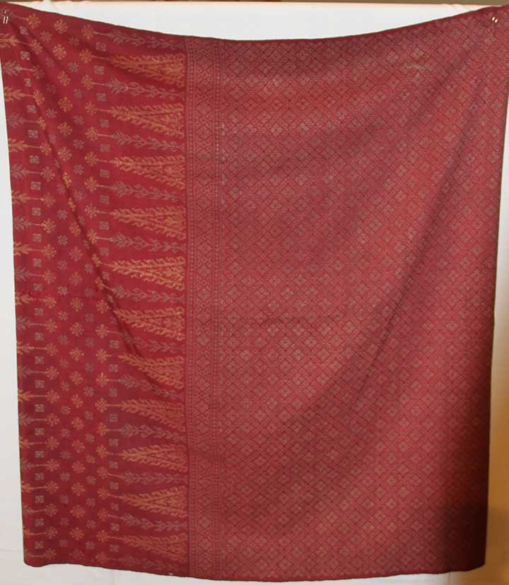 SILK SONGKET SARONG, MALAYSIA, EARLY 20TH C: Naturally dyed cranberry silk w/ metallic gold small patterned brocade, L 37", (fading & scattered holes) fair; t/w 1 Javanese cotton batik stole in tan, black & white diagonally striped pattern, exce