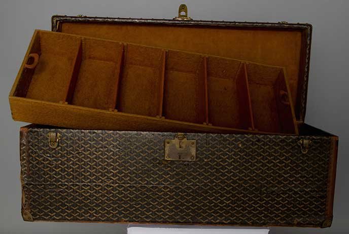 SMALL GOYARD TRUNK, EARLY 20TH C: Black canvas cloth painted w/ Goyard logo, leather trim, brass fittings, "Depose Goyard Aine" stamped on center clasp, 2 brown felt trays w/ adjustable dividers, painted monogram at each end "DRF", L 