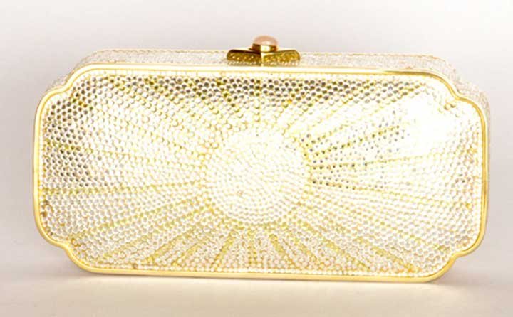 JUDITH LEIBER JEWELED EVENING BAG, LATE 20TH C: Box-shaped, covered in radiating crystals, gold frame & hardware, gold leather lining w/ matching change purse, metal comb & mirror, optional gold 38" chain, stamped "Judith Leiber," 7" x 3.5" x 1.325