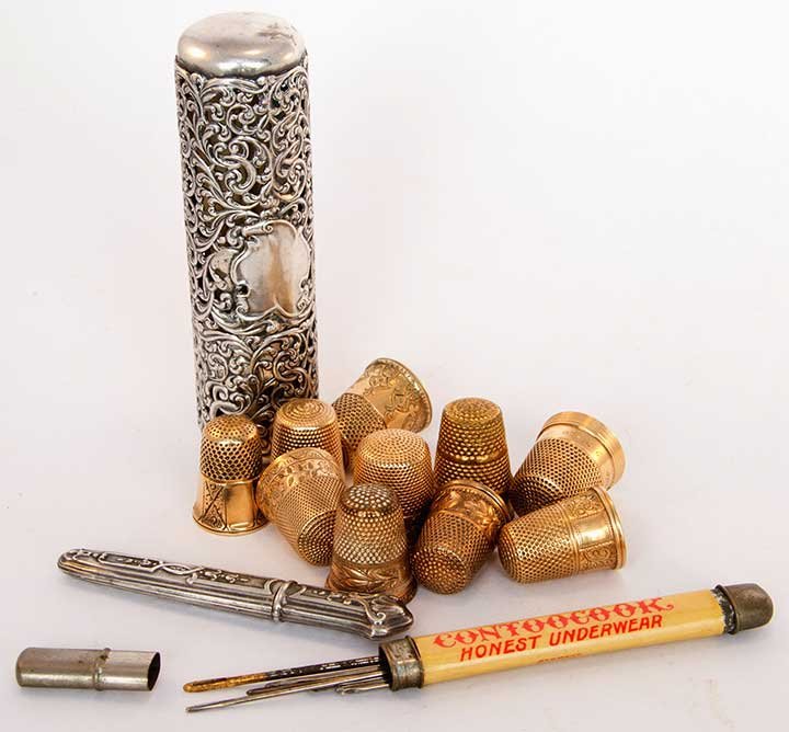 GOLD & SILVER SEWING NOTIONS, 1900-1940: 10 gold thimbles including 4 14k, 1 10k & 5 gold-filled; 4 sterling thimbles; 1 fancy silver cylindrical case for sewing implements; 1 sterling needle case; t/w 4 silver thimbles & 1 advertising needl