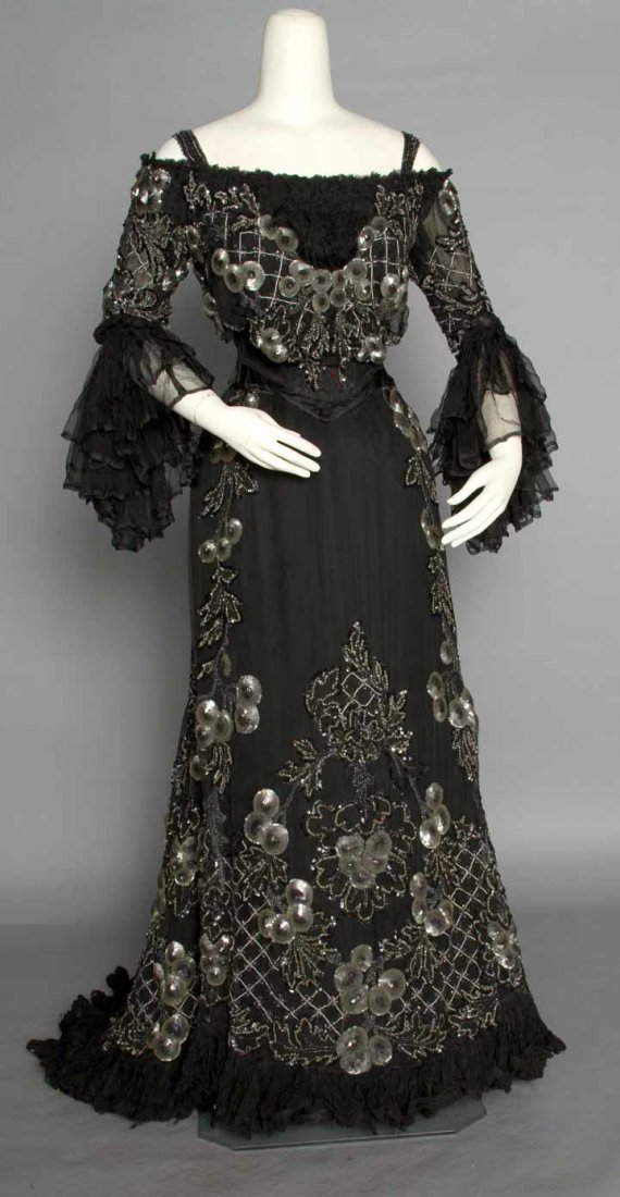 BLACK CHIFFON & SEQUIN BALLGOWN, c. 1905: 2-piece, black chiffon over black silk, trimmed in nipple shaped ombre gray sequins & lattice pattern cut steel beads, off the shoulder bodice w/ narrow shoulder straps, chiffon flounced sleeves, trai