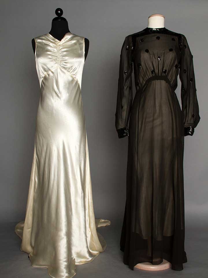 TWO EVENING GOWNS, 1930s: 1 ivory charmeuse wedding gown, sleeveless w/ long train, B 34", W 29", L 59"-100", (few stains & pulls); 1 black chiffon w/ black sequin polka dot bodice trim, B 36", Hi W 28, L 59", (1 very small ho