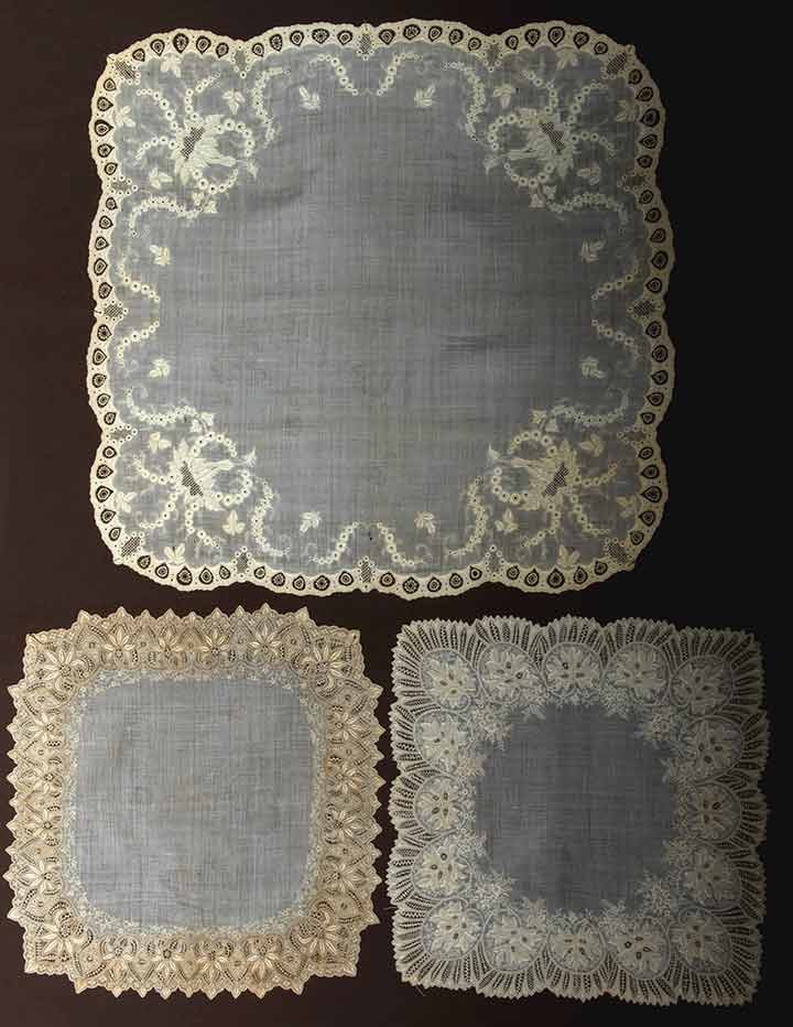 THREE EMBROIDERED WEDDING HANKIES, 1840-1860: All cream linen w/ handmade needle lace fillings: 1 large c. 1840, (many small holes) fair; 2 1850-1870 Appenzel embroidered, excellent; t/w 1 Appenzel embroidered organdy scarf, fair.