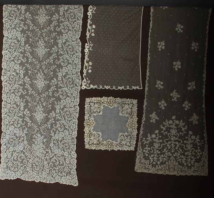 FOUR PIECES CREAM LACE, c. 1900: 1 long Carrickmacross applique stole in shamrock & bow pattern, 20" x 126"; 1 machine-made bobbin lace stole w/ hand done needle run cordonnet, 24" x 102"; 1 princess lace hat veil, 15" x 57" (small b
