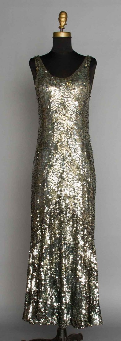 SILVER EVENING GOWN, 1930s: Gown covered w/ silver sequins in chevron pattern, sleeveless, low back, low fluted skirt, blue-gray silk lining, B 30", H 34", L 51", (minor sequin loss) excellent.